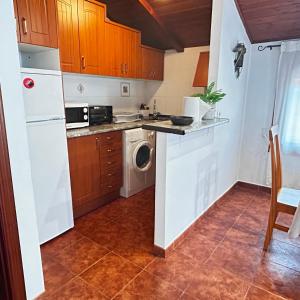 a kitchen with a white refrigerator and a dishwasher at Apartamento Tres in Guadalaviar +7 photos