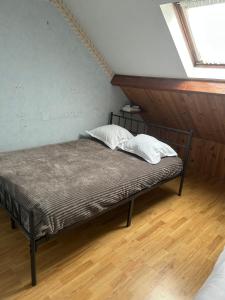 a bed with two pillows on it in a room at une détente à la campagne in Chierry +4 photos