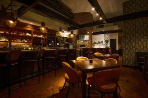a restaurant with tables and chairs and a bar at Archer Hotel Old Town Alexandria in Alexandria