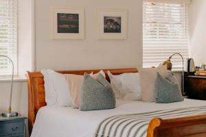 a bedroom with a bed with white sheets and pillows at The Ram Inn in Lewes