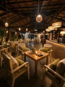 a restaurant with tables and chairs in a room at MK Hill resort Phu Quoc in Phú Quốc +37 photos