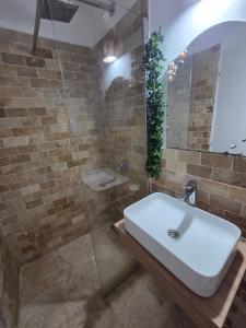 a bathroom with a sink and a glass shower at YANNIS GUEST HOUSE in Costinesti +26 photos
