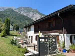 a house with mountains in the background at Ferienwohnung Schneider in Vandans
