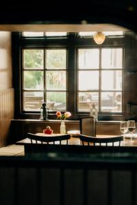 a kitchen with two windows and a table with two chairs at The Ram Inn in Lewes