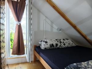 a bedroom with a bed and a window at Marin konak in Gornji Milanovac
