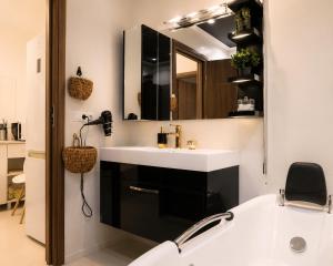 a bathroom with a white sink and a mirror at Azur House2 in Cluj-Napoca +14 photos