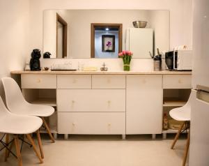 a kitchen with a counter with a sink and a microwave at Azur House2 in Cluj-Napoca