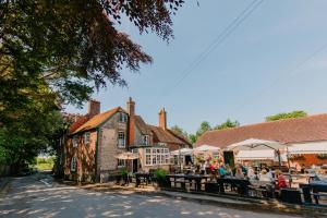a group of people sitting at tables outside a building at The Ram Inn in Lewes +13 photos