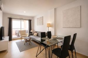 a living room with a table and a couch at Condado de Alhama - Suchan living in El Romero