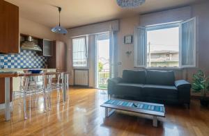 a living room with a couch and a table at Ornella's apartment Relax-Wi-Fi e AC- ideale famiglie in Casale di Scodosia