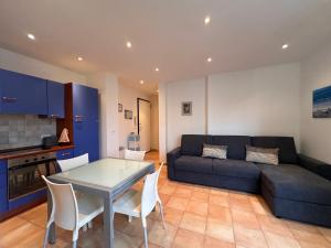 a living room with a blue couch and a table at HENRY BENNEt in Menton