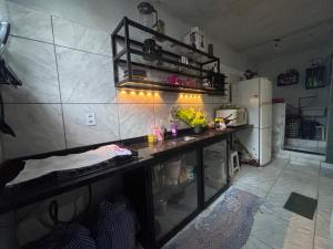 a kitchen with a counter and a refrigerator at Beco 6 in Petrópolis