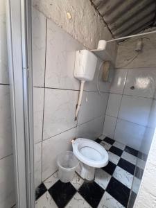 a bathroom with a white toilet and a bucket at Beco 6 in Petrópolis