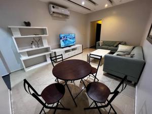 a living room with a table and chairs and a couch at شقة مخدومة 101 in Medina