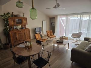 a living room with a couch and a table and chairs at Chez mamie in La Rochelle