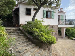 a house with stairs leading up to a house at Les messugues aux issambres in La Garonnette-Plage