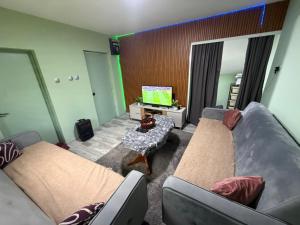 a living room with two couches and a tv at Konak Vuk in Veruša