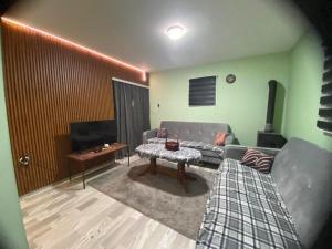 a living room with a couch and a table at Konak Vuk in Veruša