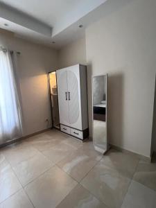 an empty room with a refrigerator in the corner at New Alamein Latine district Spacious studio direct Lagon view in El Alamein