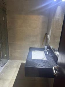 a bathroom with a sink and a mirror at New Alamein Latine district Spacious studio direct Lagon view in El Alamein +13 photos
