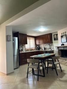 a kitchen with a table and chairs and a refrigerator at Matina's cozy home close to Monemvasia in Áyios Sarándos