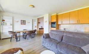 a living room with a couch and a table at Magnifique appartement avec vue sur les sommets enneigés in Crans-Montana +22 photos