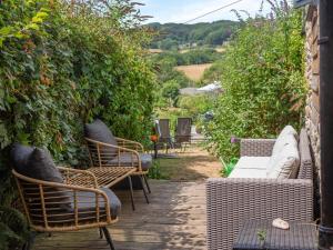 a group of chairs and tables on a patio at 3 Bed in Eype oc-e34183 in West Bay