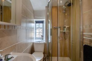 a bathroom with a toilet and a sink and a shower at 3 Bed in Eype oc-e34183 in West Bay +19 photos