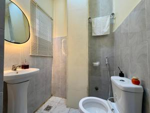 a bathroom with a toilet and a sink and a mirror at Haven 21 in Aja