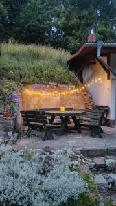 a wooden bench sitting next to a building with lights at Villa Górski Spokój in Srebrna Góra
