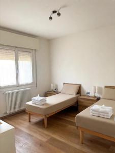 a room with two beds and a window at Casa Vecellio in Noale