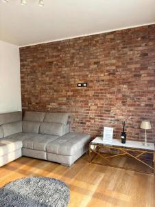 a living room with a couch and a brick wall at Casa Vecellio in Noale +10 photos
