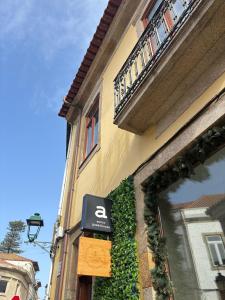 a building with a sign on the side of it at Autor Guesthouse in Vila do Conde