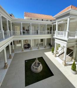an aerial view of a large mansion with a fountain at Patrimonial Hotel Boutique in Cochabamba