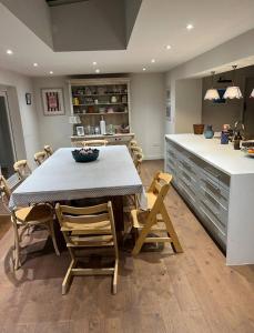 a kitchen with a table and chairs and a counter at Riverside Cottage Sleeps 8 with Parking in Marlborough