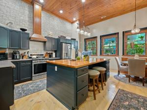 a kitchen with blue cabinets and a large island at North 40 Lodge and Cabin in Clarkesville