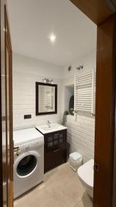 a bathroom with a washing machine and a sink at Hotel Arco Navia in Navia +41 photos