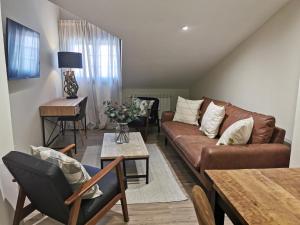 a living room with a couch and a table at Hotel Arco Navia in Navia