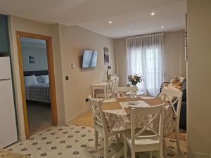 a kitchen and dining room with a table and chairs at Hotel Arco Navia in Navia