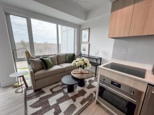 a living room with a couch and a table at Muskoka Bay Resort in Gravenhurst