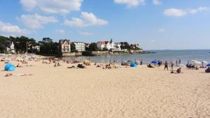 a group of people on a beach near the water at The Originals Boutique Hôtel La Villa Ouest & Spa in Saint-Palais-sur-Mer +62 photos