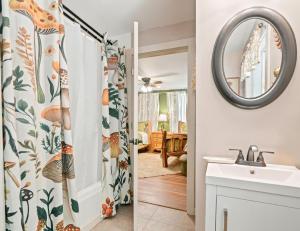 a bathroom with a shower curtain and a sink at North 40 Lodge and Cabin in Clarkesville +60 photos