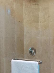 a shower with a white towel and a towel rack at Home Time Square Residence in Kuala Lumpur +24 photos