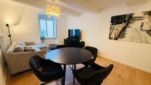 a living room with a table and chairs and a couch at Cozy Corner - Passau in Passau +14 photos