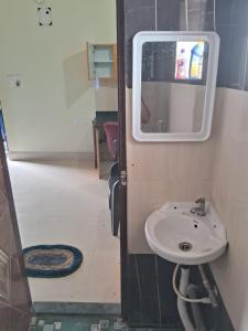 a small bathroom with a sink and a mirror at Aadyasha in Pānchagān