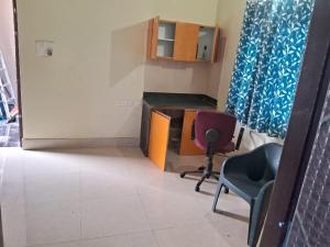 a small room with a desk and a chair at Aadyasha in Pānchagān