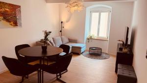 a living room with a table and a couch at Cozy Corner - Passau in Passau