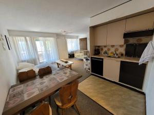 a kitchen with a table and chairs in a room at Davos Swiss Alps in Davos