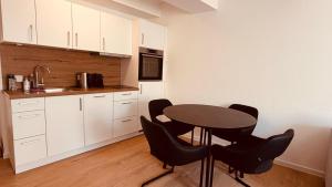 a kitchen with a table and black chairs at Cozy Corner - Passau in Passau