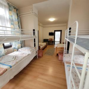a room with three bunk beds and a desk at Ezüstfenyő Üdülő Visegrád in Visegrád